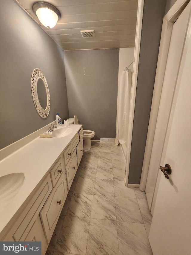 980 Creek Rd, Downingtown, PA 19335 - full bathroom with marble look tile flooring, double vanity, toilet, a shower with curtain, and baseboards