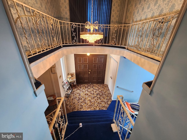 980 Creek Rd, Downingtown, PA 19335 - stairway featuring carpet flooring, arched walkways, and a chandelier