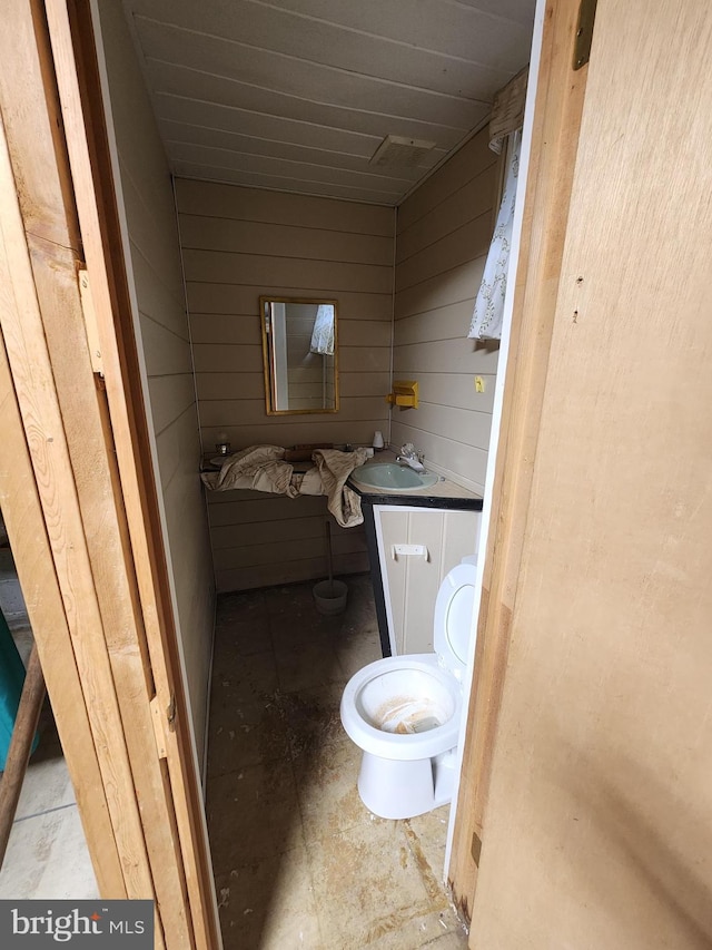 980 Creek Rd, Downingtown, PA 19335 - half bathroom with wood walls, toilet, and vanity