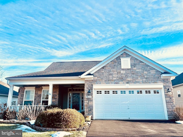 view of front of property featuring a garage and covered porch