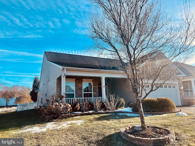 ranch-style house featuring a garage, covered porch, and a front yard