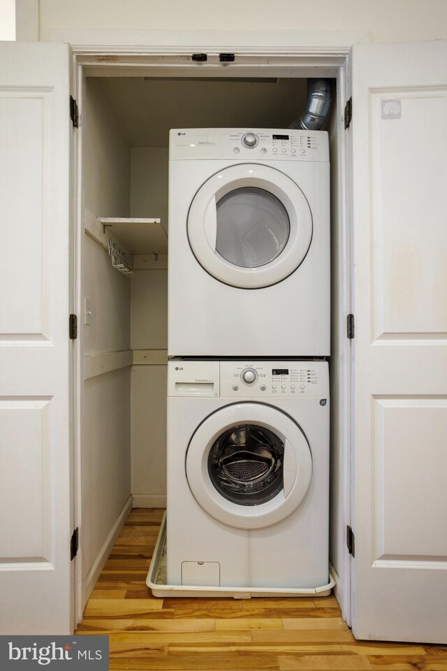 1215 N Hancock St, Philadelphia, PA 19122 - clothes washing area with stacked washer and dryer and light wood-type flooring