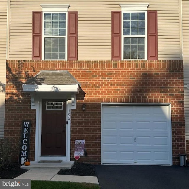 doorway to property with a garage