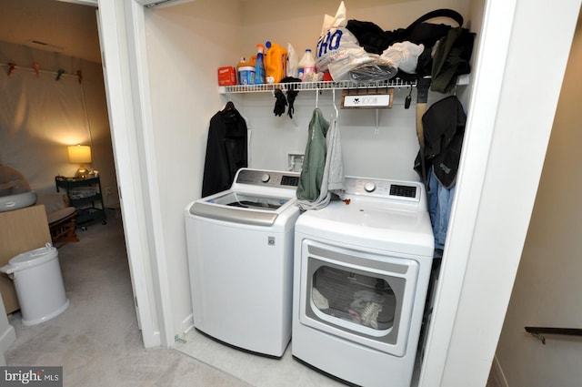 clothes washing area featuring independent washer and dryer