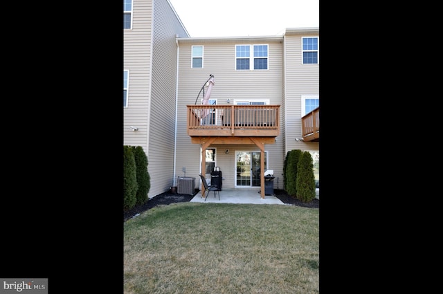 back of property featuring a balcony, a yard, a patio area, and central air condition unit