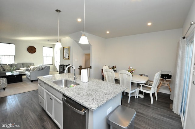 kitchen with sink, white cabinetry, stainless steel dishwasher, an island with sink, and pendant lighting