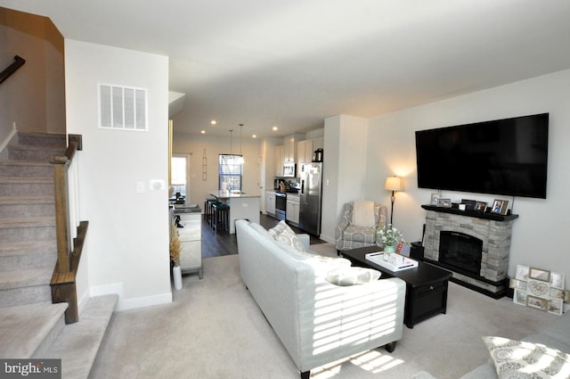 carpeted living room featuring a fireplace