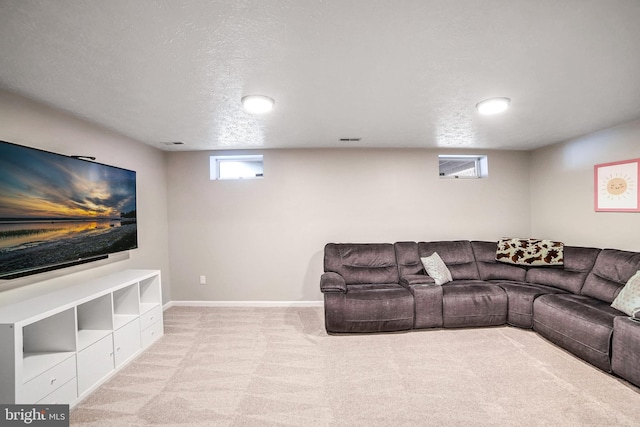 carpeted living room featuring a textured ceiling