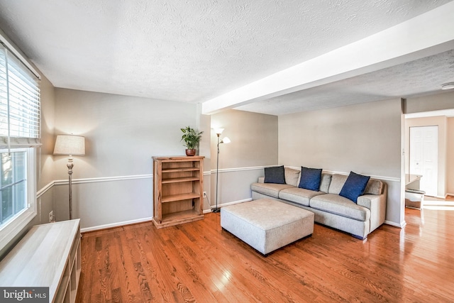 living room with light hardwood / wood-style flooring and a textured ceiling