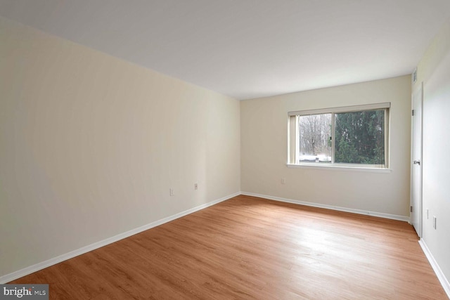 empty room with light hardwood / wood-style flooring