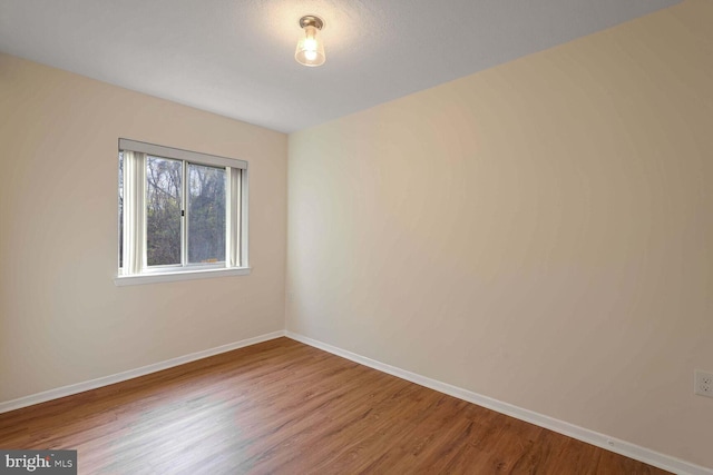 unfurnished room with hardwood / wood-style floors