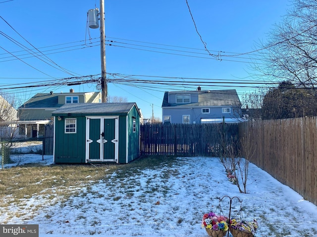 snowy yard with a shed