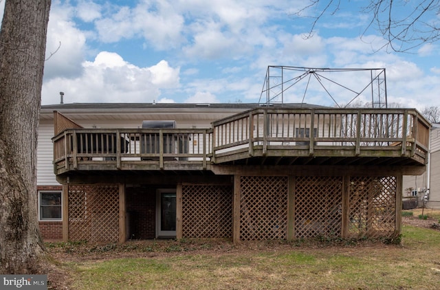 back of house featuring brick siding and a deck