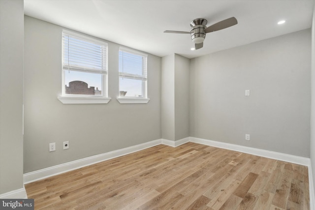 empty room featuring ceiling fan and light wood-type flooring