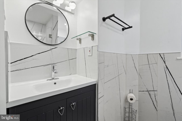 bathroom with vanity and tile walls