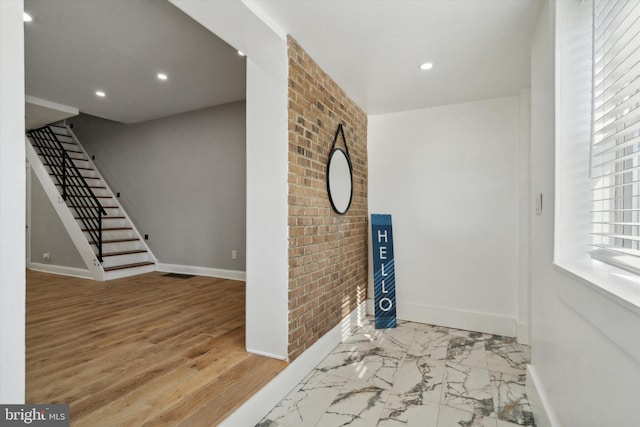 foyer entrance with brick wall