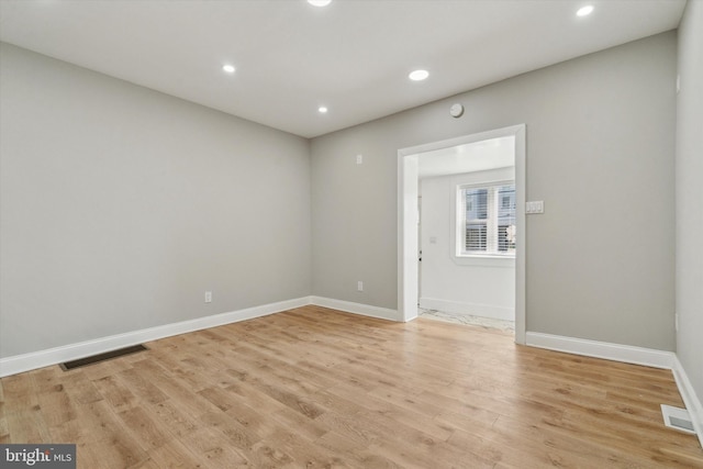 spare room with light hardwood / wood-style flooring