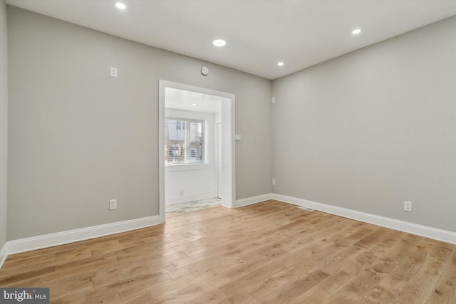 unfurnished room with light wood-type flooring