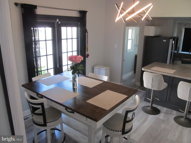 348 Broad St, Mount Holly, NJ 08060 - dining room featuring healthy amount of natural light, a chandelier, and wood finished floors