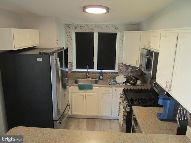 348 Broad St, Mount Holly, NJ 08060 - kitchen with appliances with stainless steel finishes, a sink, and white cabinetry