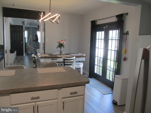 348 Broad St, Mount Holly, NJ 08060 - kitchen featuring french doors, plenty of natural light, white cabinetry, and light wood-style floors