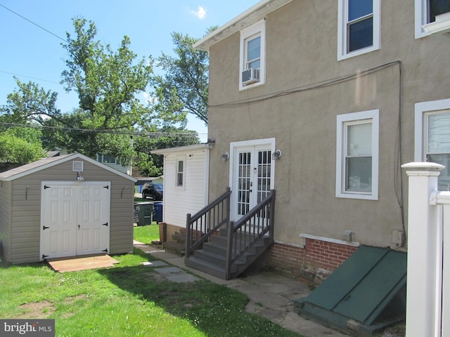 348 Broad St, Mount Holly, NJ 08060 - back of house with french doors, a storage unit, an outdoor structure, and stucco siding