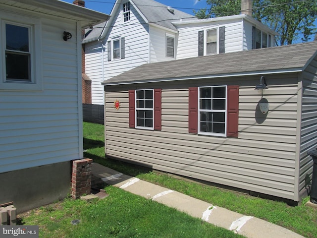 348 Broad St, Mount Holly, NJ 08060 - view of side of home featuring an outbuilding, roof with shingles, and a chimney