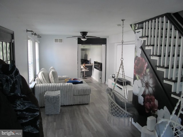 348 Broad St, Mount Holly, NJ 08060 - living area with wood finished floors, stairway, and a ceiling fan