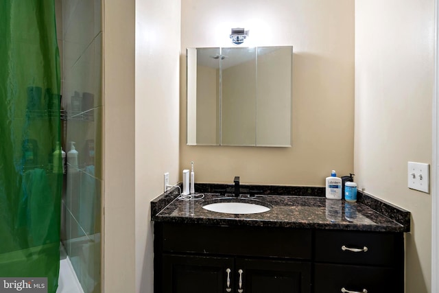 full bathroom featuring a washtub, vanity, and a shower with curtain