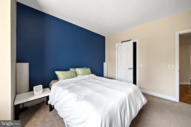 carpeted bedroom featuring baseboards