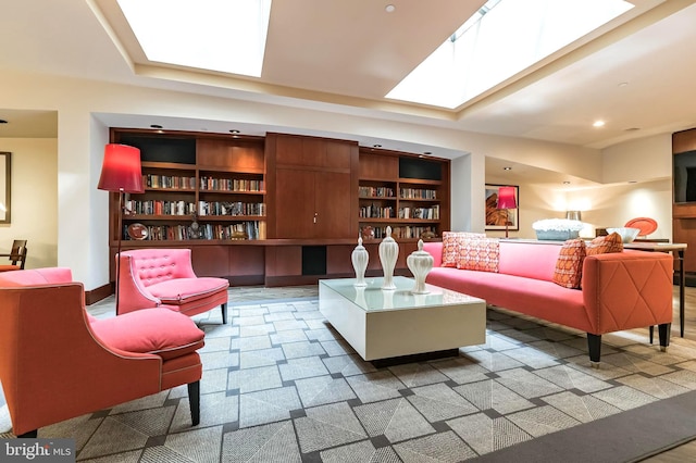 living area with built in shelves and a skylight