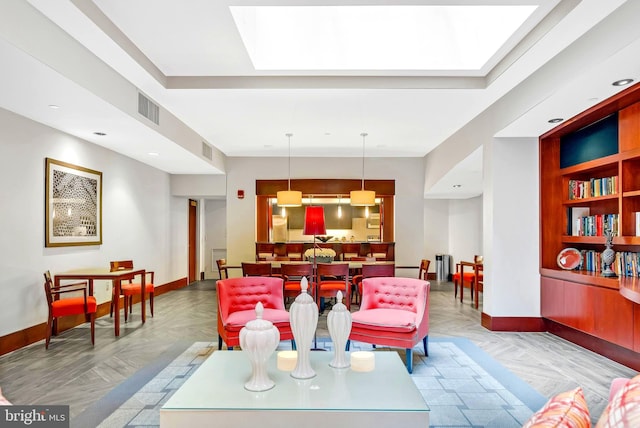 interior space featuring visible vents, baseboards, and a skylight