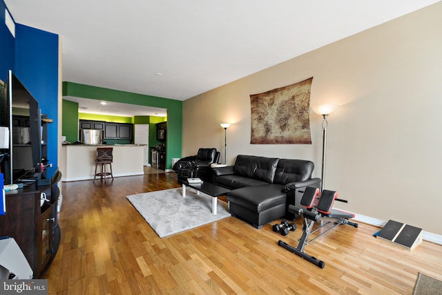 living area featuring baseboards and wood finished floors