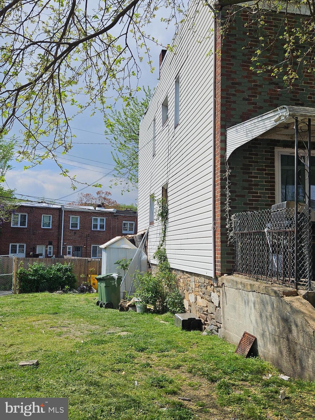 view of property exterior featuring a yard and a shed