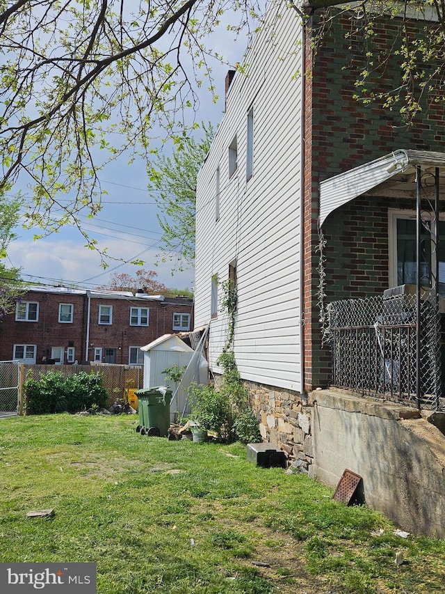 view of property exterior featuring a yard and a shed