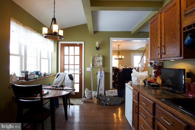 kitchen with an inviting chandelier, dark hardwood / wood-style flooring, sink, and hanging light fixtures