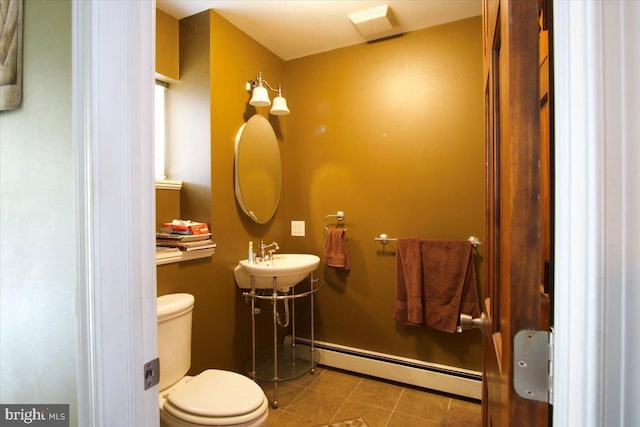 bathroom with a baseboard radiator, toilet, tile patterned flooring, and sink