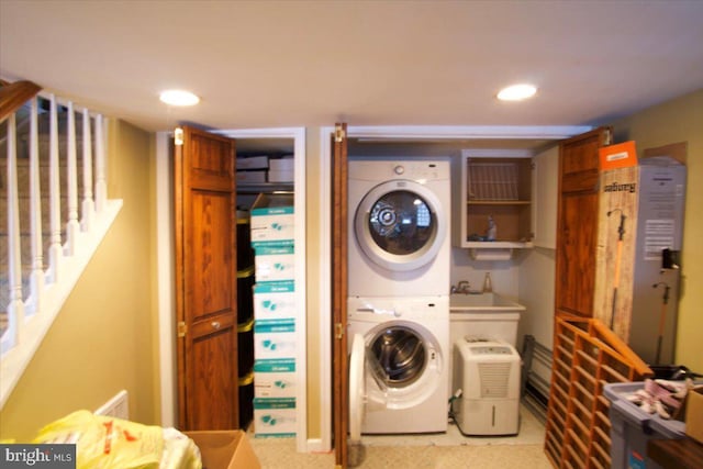 clothes washing area featuring stacked washer and dryer