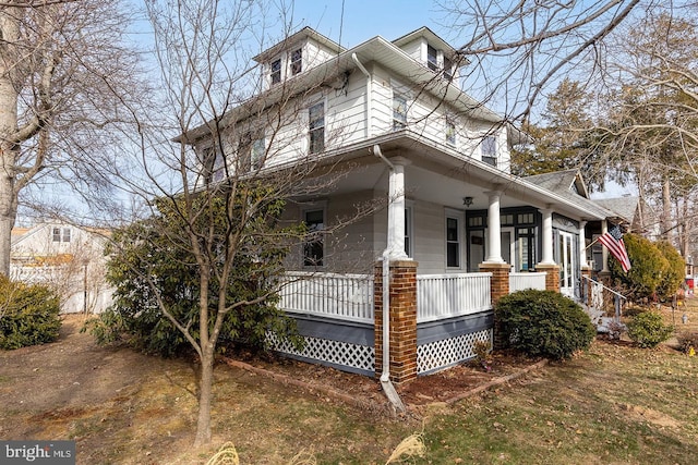 view of side of property with a porch