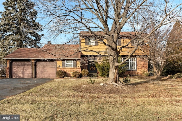 view of front of house featuring a garage and a front yard