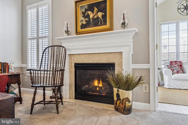 living area with a healthy amount of sunlight, a fireplace, and carpet