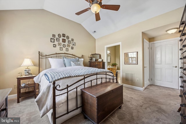 carpeted bedroom featuring ensuite bathroom, lofted ceiling, and ceiling fan