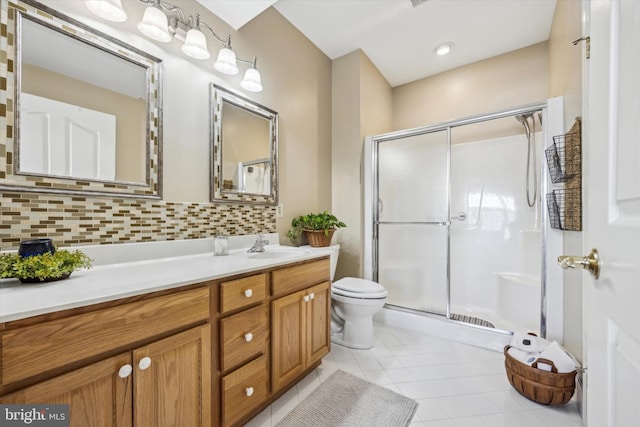 bathroom featuring a shower with door, vanity, tile patterned flooring, and decorative backsplash