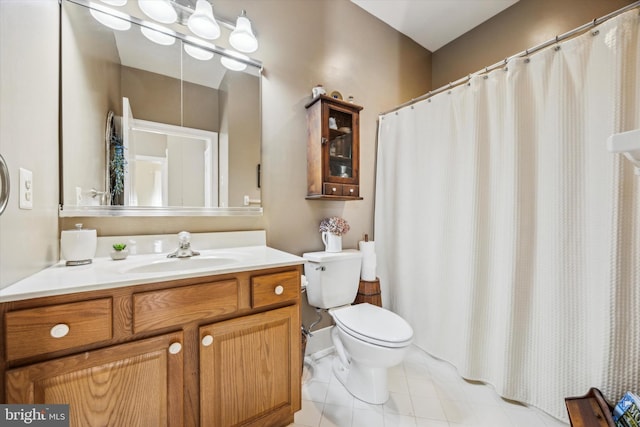 bathroom featuring vanity, toilet, and tile patterned flooring