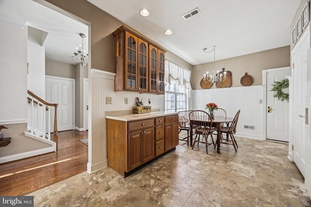 kitchen featuring pendant lighting and a chandelier