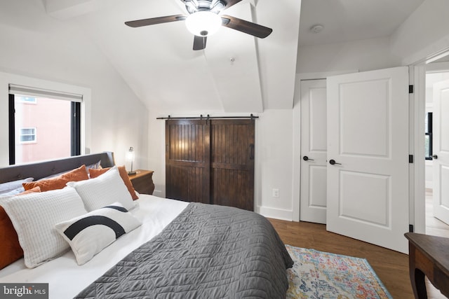 bedroom with vaulted ceiling, ceiling fan, and dark hardwood / wood-style flooring