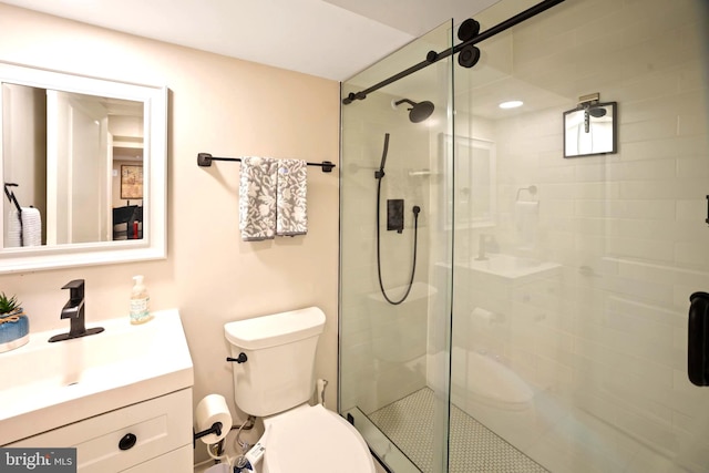 bathroom featuring vanity, toilet, and an enclosed shower