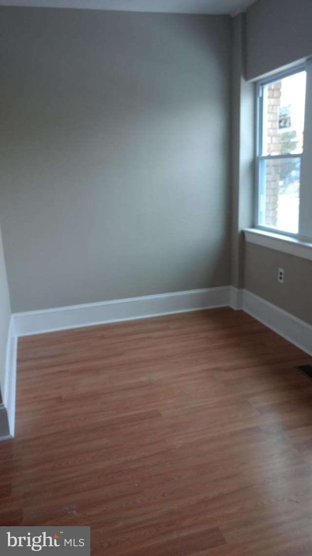 spare room featuring hardwood / wood-style flooring