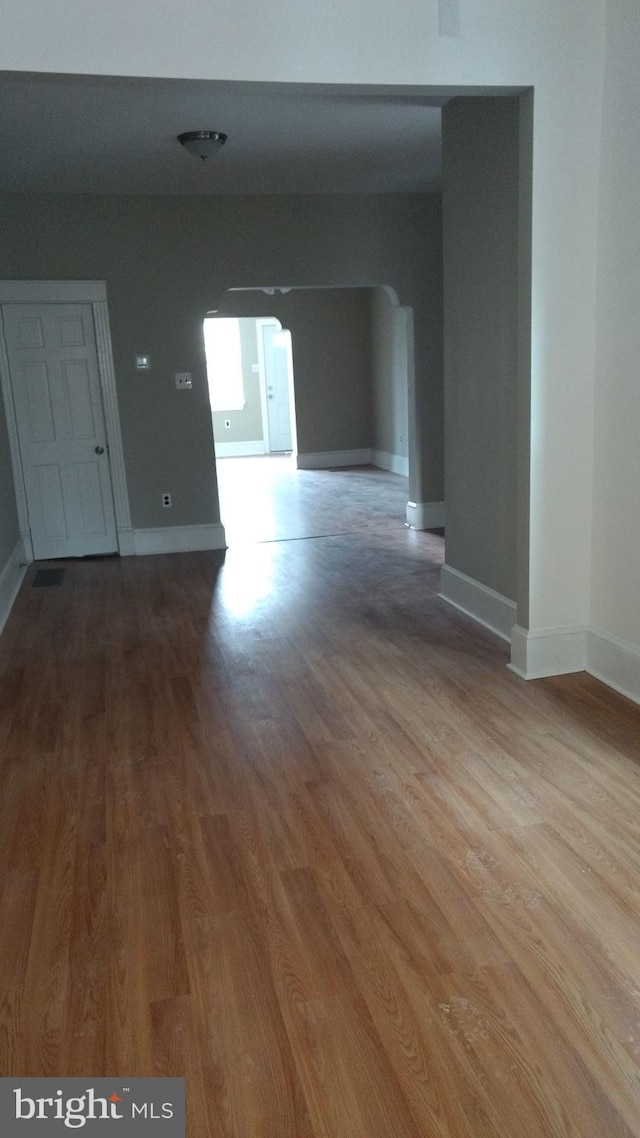 unfurnished room with hardwood / wood-style flooring