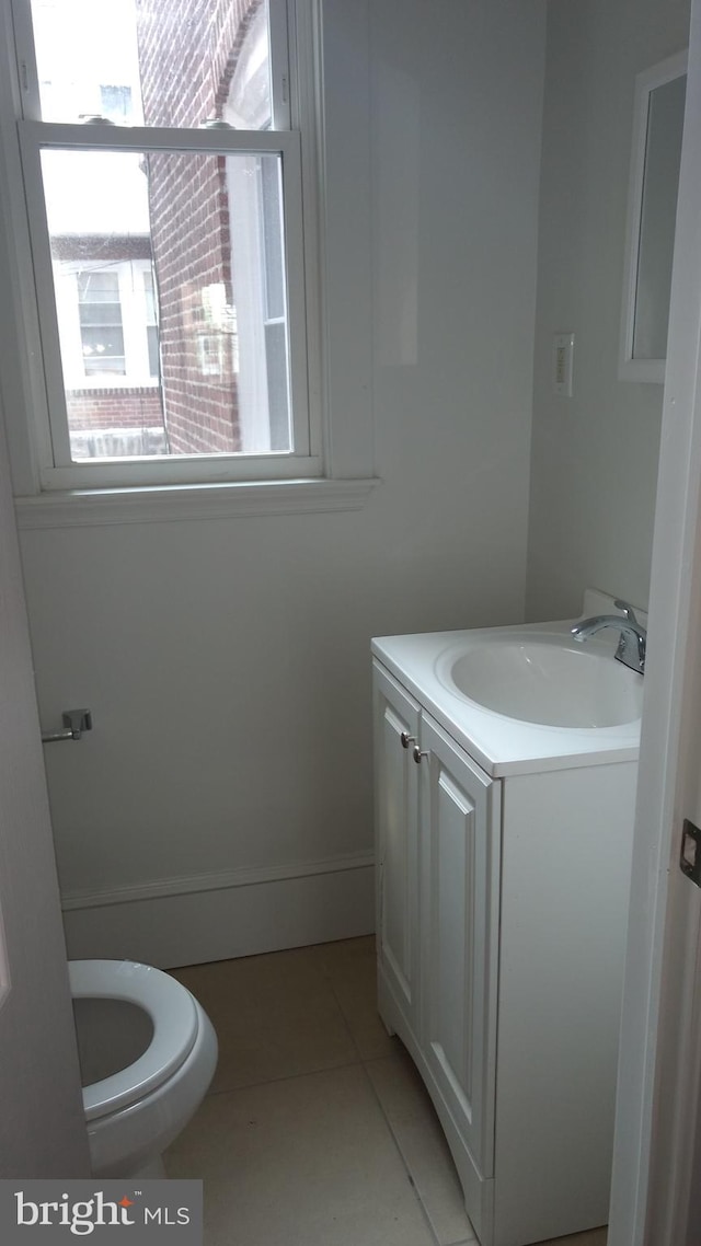 bathroom with tile patterned floors, vanity, and toilet